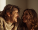 Couple laughing together warmly on a couch